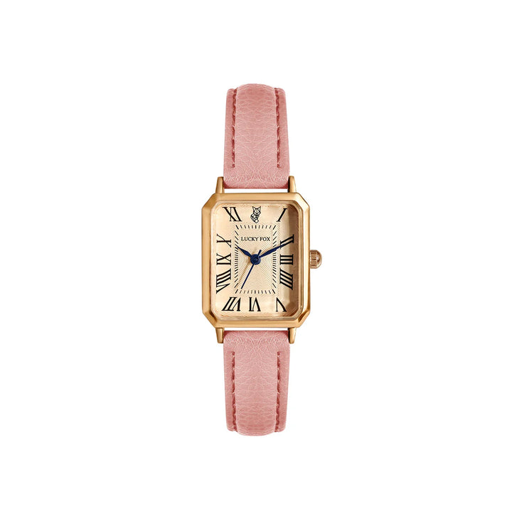 A gold rectangular face watch with a beige dial, black Roman numerals, a genuine leather pink strap, and blue watch hands, shown against a white background.
