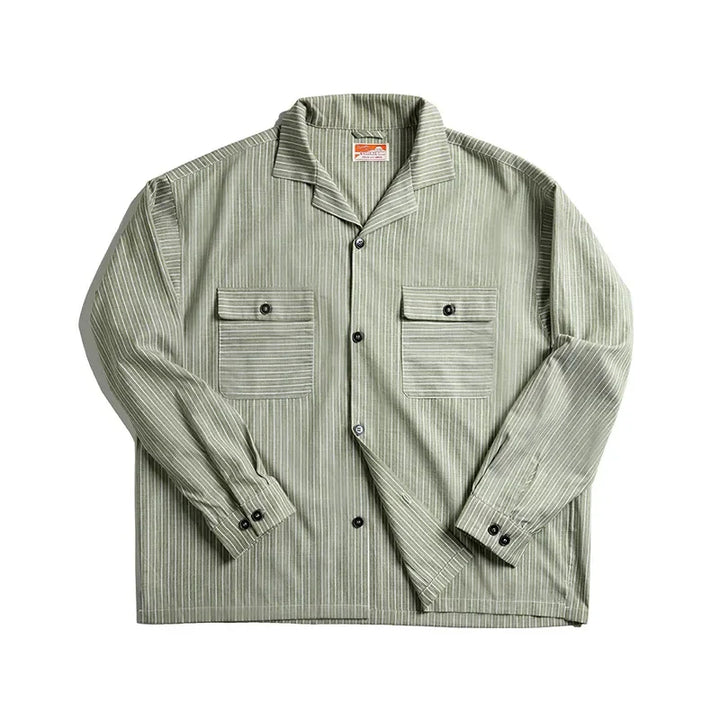 A green and white pinstripe shirt with a Cuban collar and two front chest pockets, each with a buttoned flap, crafted from high-quality cotton and displayed on a white background.