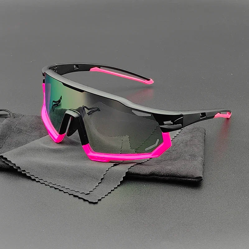 Olympus Sunglasses with a black frame and bright pink accents rest on a black cleaning cloth. These sporty shades feature polarized lenses for UV protection, and their reflective, slightly tinted finish stands out against the dark background.