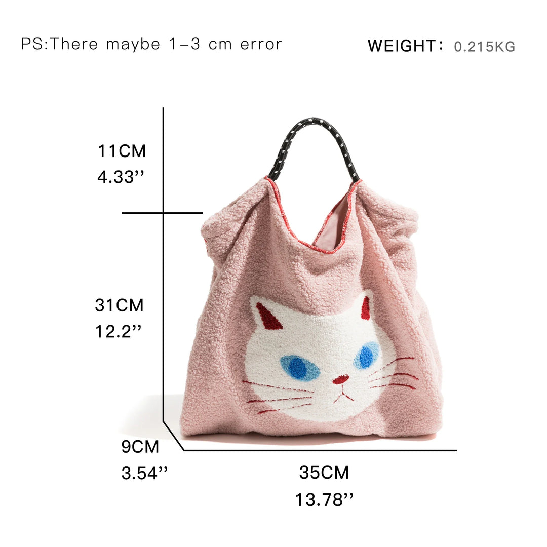 A pink lamb like fabric tote bag with a white cat face design, black and red handles, and dimensions of 31 cm tall, 35 cm wide, and 9 cm deep. Text notes a possible 1–3 cm error and weight of 0.215 kg.