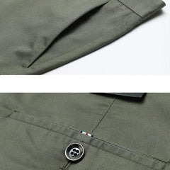 Close-up of olive green pants featuring a slanted side pocket above and a back pocket with button and stitched flag detail below, showcasing their 4 way stretch fabric for versatile style.