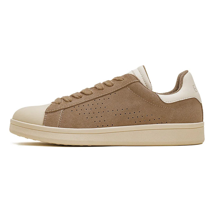 A tan and beige Lowland Odyssey Sneaker featuring a suede upper, perforated side panel, beige toe cap, and matching sole is shown in a left side profile view against a white background—an ideal minimalist sneaker with timeless style.