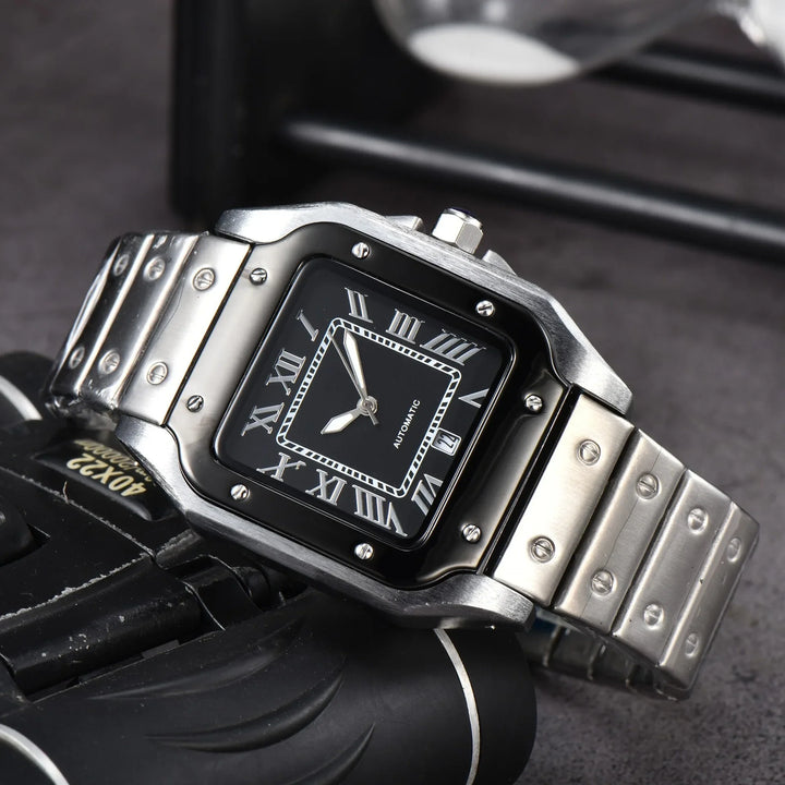 A silver metal wristwatch with a rectangular black face, Roman numeral hour markers, and three silver hands, displayed on a dark surface. Swiss Craftsmanship and visible screws enhance its bezel and band.