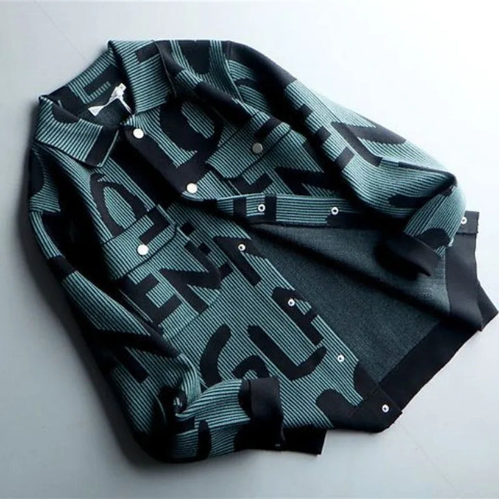 A stylish Korean loose fit, dark teal and black button-up jacket with bold, oversized black letters in a graphic pattern, laid flat on a light surface.