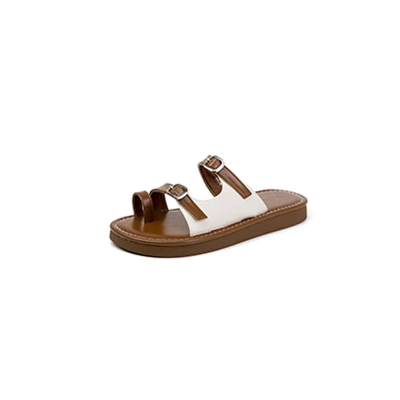 A brown and white open-toe sandal with a leather upper, two adjustable dual buckle straps, and a flat non-slip rubber sole, displayed on a white background.