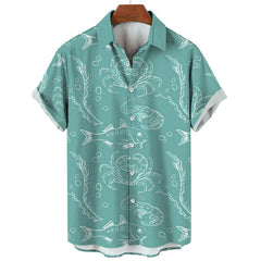 A summer-ready, short-sleeve teal button-up shirt with white line drawings of sea creatures—fish, crabs, shrimp, seaweed, and bubbles—brings an ocean-inspired vibe to your wardrobe. Displayed on a wooden hanger.