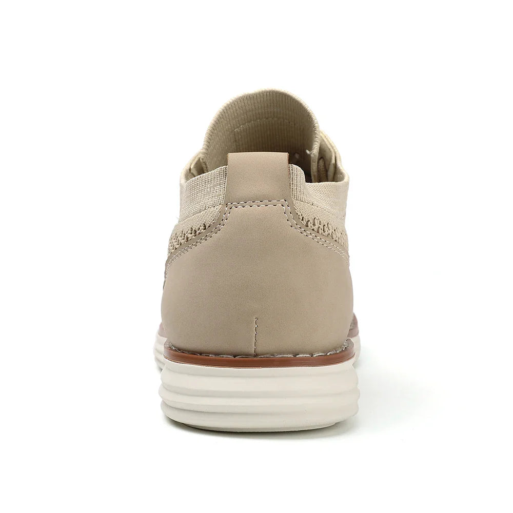 Beige lightweight sneaker shown from the back, featuring a white cushioned sole, tan leather heel, woven fabric details, and a pull tab at the heel collar—ideal for versatile business casual shoes.