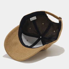 A tan Unisex Streetwear Cap shown from above, revealing the black inner lining, stitching, and a white label inside. The cap's adjustable strap is visible at the back.
