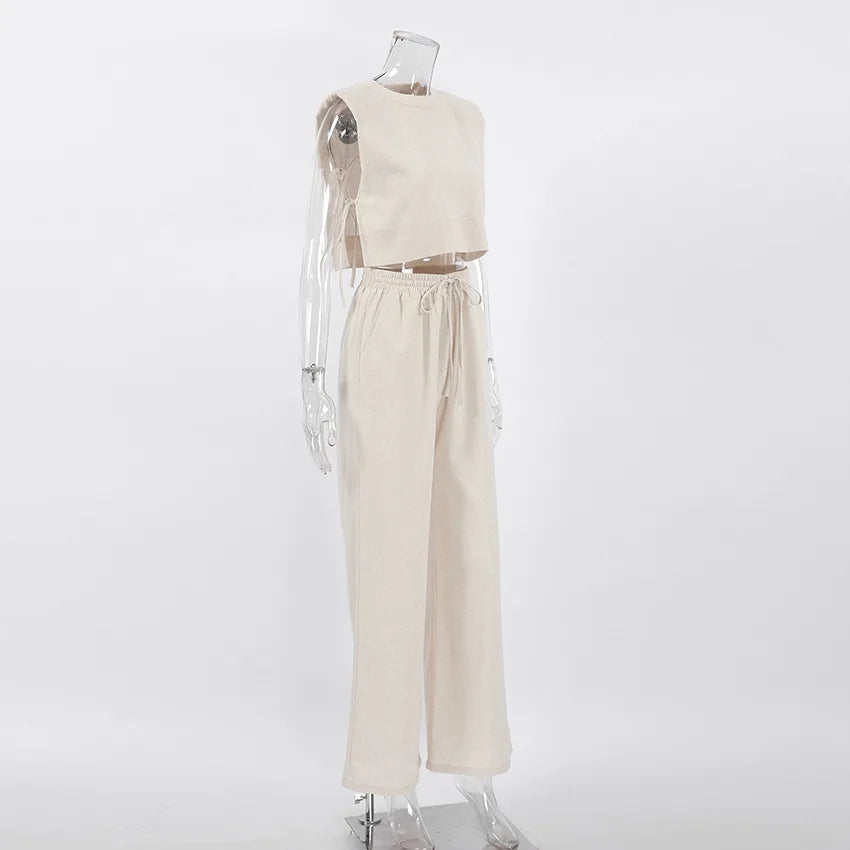 A clear mannequin is dressed in a sleeveless cropped top and matching high-waisted wide-leg pants in a Belgian Linen Blend, displayed against a plain white background.