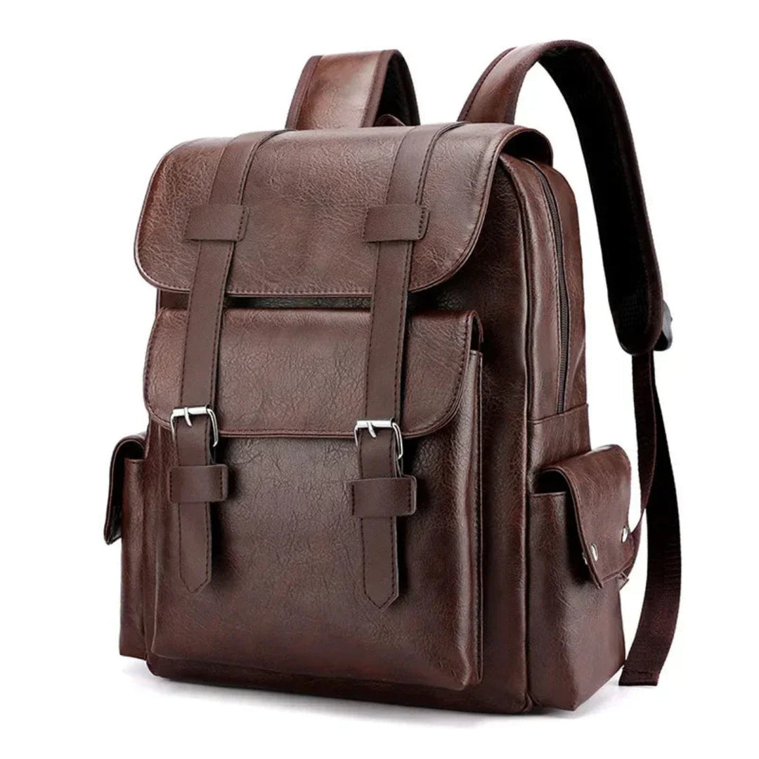 A brown leather backpack with spacious compartments, a large front flap, buckle straps, side pockets, and adjustable shoulder straps, standing upright on a white background.