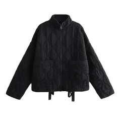 A black quilted bomber jacket with a high collar, front zipper, two large front pockets, and long sleeves. The jacket features padded insulation, a loose fit, and subtle stitched wave patterns throughout.