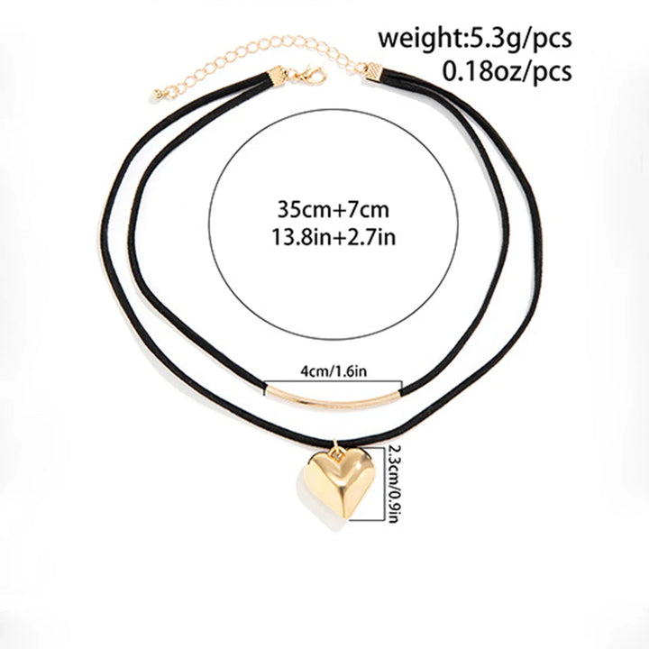 Double black cord velvet choker with a vintage heart pendant and a gold bar charm. Adjustable choker length: 35 cm plus 7 cm extension. Heart is 2.3 cm tall. Total weight: 5.3g (0.18oz).