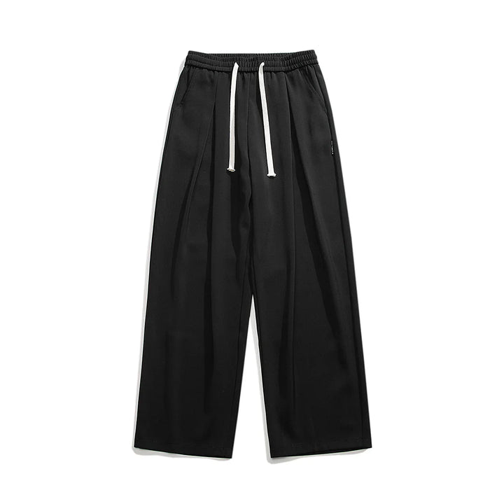Wide-leg black streetwear joggers with an elastic waistband and white drawstrings, crafted from soft ice-silk fabric, laid flat on a white background.