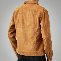 A person wearing a tan suede jacket with a classic point collar and dark jeans is shown from the back against a plain gray background.