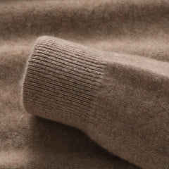 Close-up of a soft, brown pure wool sweater sleeve laid flat, highlighting the ribbed cuff and fuzzy wool craftsmanship.
