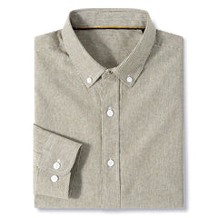 A neatly folded, classic pinstripe shirt with thin black and white vertical stripes. This cotton button-up features a collar and white buttons on the front and cuffs, combining timeless style with everyday comfort.