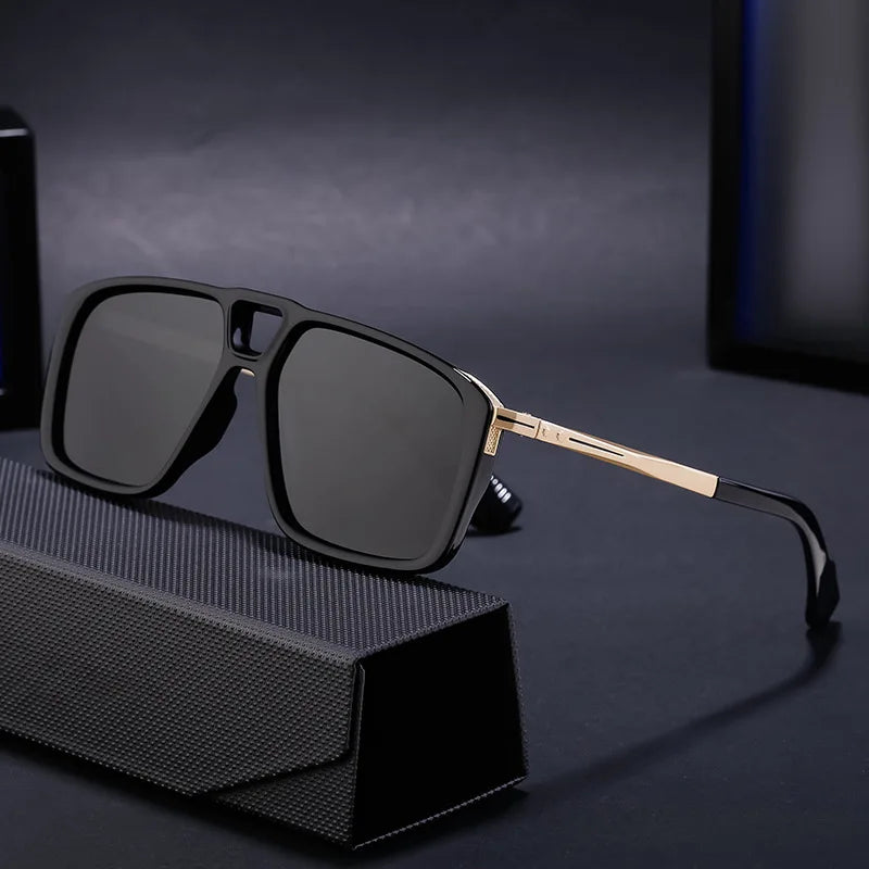Rectangular black polarized sunglasses with gold-toned arms rest on a textured black case, set against a dark background. Enjoy UV protection in this limited-edition eyewear.