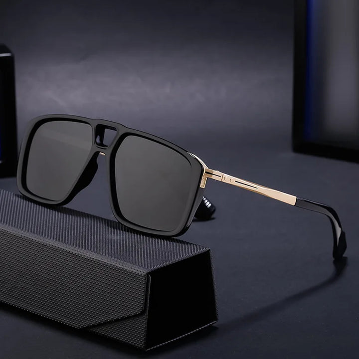 Rectangular black polarized sunglasses with gold-toned arms rest on a textured black case, set against a dark background. Enjoy UV protection in this limited-edition eyewear.