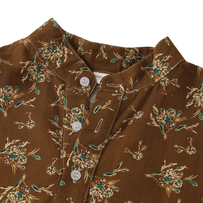 Brown cotton shirt with a mandarin collar, floral print in green and cream, and white buttons down the front. The lightweight fabric and classic design make it perfect for casual wear.