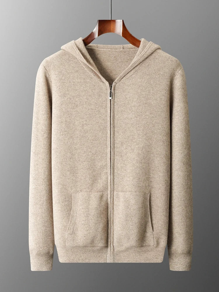 A beige zip-up hoodie with front pockets and a hood, displayed on a wooden hanger against a gray background, perfect as an autumn winter sweater for effortless men's casual cardigan style.