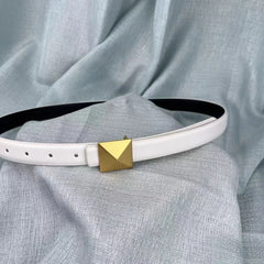 A white leather belt with an adjustable length and a gold pyramid-shaped buckle is displayed on a light blue textured fabric background.