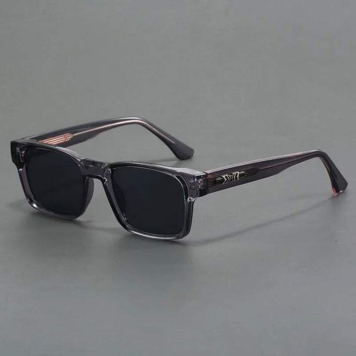 Rectangular black sunglasses with UV400 protection, dark lenses, and thick, slightly translucent frames are displayed on a plain gray surface.