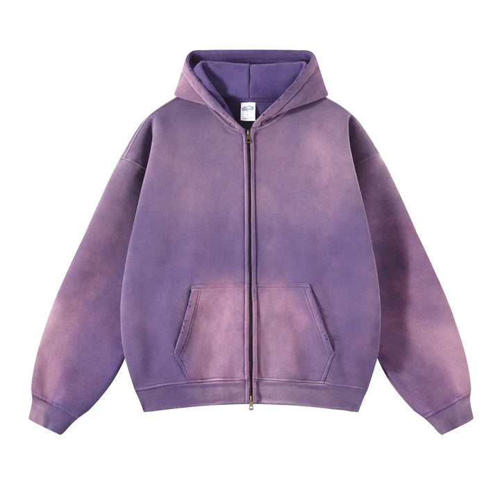 A purple zip-up hoodie with a faded, spray-dyed vintage effect, front pockets, and a hood, made from thickened fabric and laid flat on a white background.