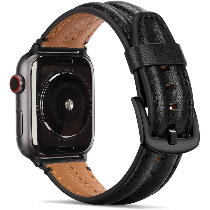 A close-up view of a leather Apple Watch band shows a brown leather underside and black top strap, featuring black stitching and a black metal buckle. The sensor and text details on the watch’s back are clearly visible.