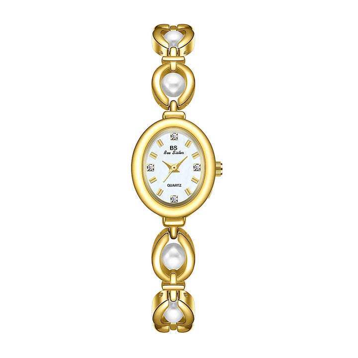 A gold-tone women’s wristwatch with an oval white face, diamond-like hour markers, and a bracelet-style band featuring gold links and elegant pearl accents.