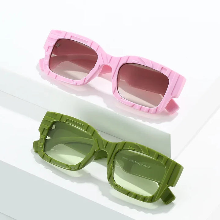 Two pairs of chunky, square vintage sunglasses with textured frames; one pink with light pink lenses, the other green with green-tinted lenses. Both offer UV400 protection and are displayed on a white background.