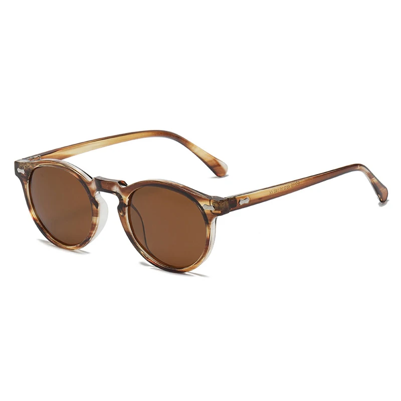 Brown round-lens sunglasses with a translucent, light brown tortoiseshell frame offer UV400 protection. These trendsetting sunglasses are shown from a front angled perspective on a white background.