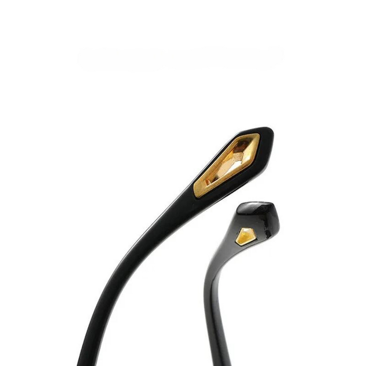 Close-up of the black temple arms of rectangular sunglasses, featuring a gold hexagonal detail near the tips, against a plain white background.