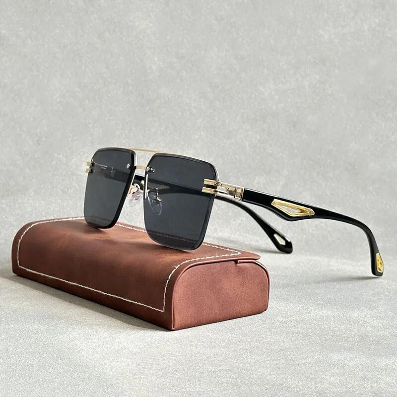 A pair of square, black-rimmed rectangular sunglasses with gold accents and scratch resistant lenses is displayed on a brown, rectangular glasses case against a light gray background.