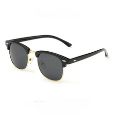 A pair of black and gold clubmaster-style vintage sunglasses with dark lenses, featuring a black top frame, gold lower rims, and black arms with silver accents near the hinges for classic style and UV protection.
