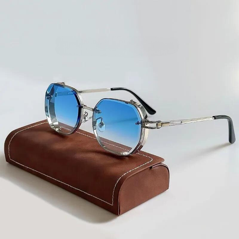 A pair of round, silver-framed eclectic sunglasses with blue gradient lenses rests on a brown, rectangular glasses case with white stitching, set against a light background.