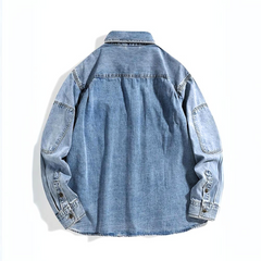 A light blue rugged denim shirt shown from the back, featuring long sleeves, buttoned cuffs, and a classic collar. The fabric has a slightly faded wash, giving it a casual, worn-in look.