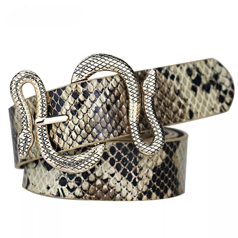 A faux-snakeskin belt with a gold, snake-shaped buckle, coiled in a loop and displaying detailed scales, features an antique patina finish for added depth and a realistic reptile design.