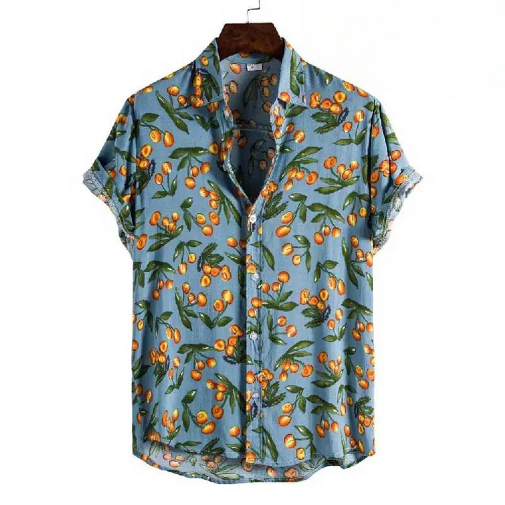 A relaxed fit shirt with short sleeves and a button-up front, featuring a blue background with orange fruit and green leaf patterns, displayed on a hanger.