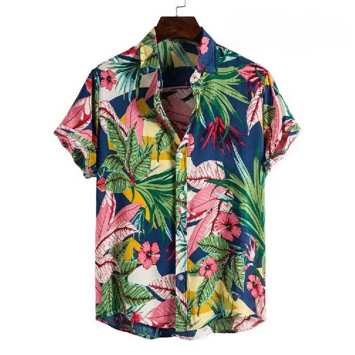 A short-sleeved, button-up floral shirt with a vibrant tropical print of green leaves and pink flowers on a blue background, made from easy-care material and displayed on a hanger.