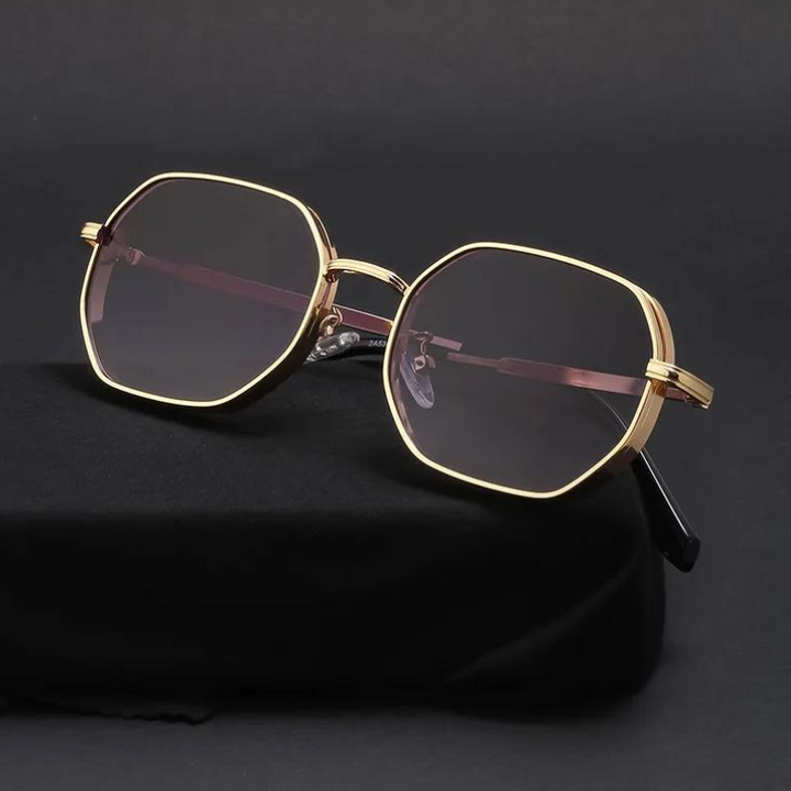 Gold-tone frames and dark tinted lenses give these geometric-shaped, vintage-inspired sunglasses a stylish edge. Displayed on black fabric against a dark background, they also offer essential UV400 protection.