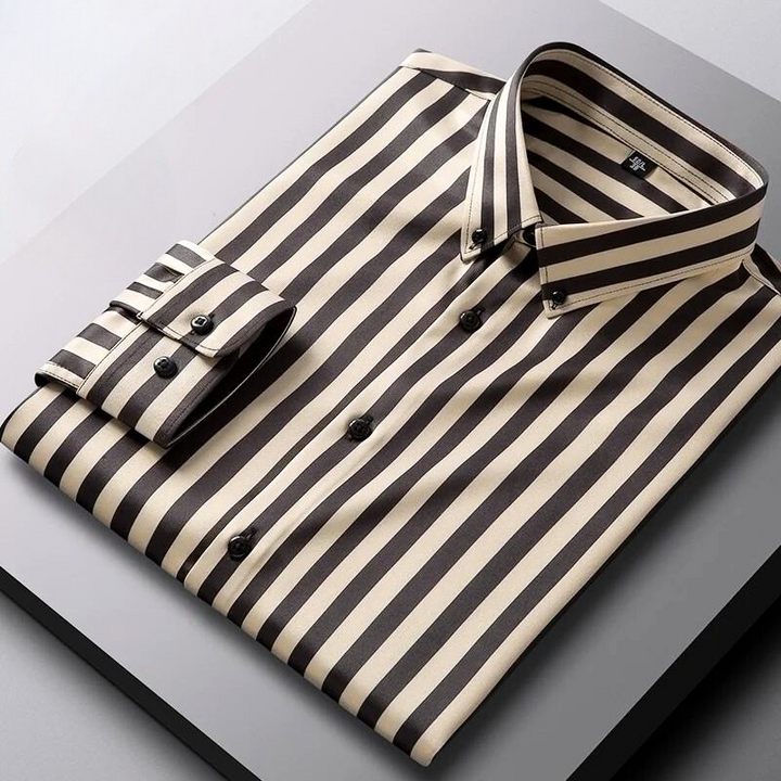 A neatly folded Hamilton Executive Classic Fit Shirt with black and beige vertical stripes is displayed on a flat, gray surface, showcasing its premium fabric and timeless style.