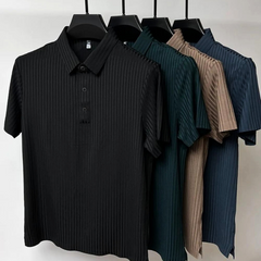 Four short-sleeved, collared shirts with vertical stripes and a classic polo design hang on black hangers. The shirts, in black, dark green, beige, and blue, are displayed against a plain white background.