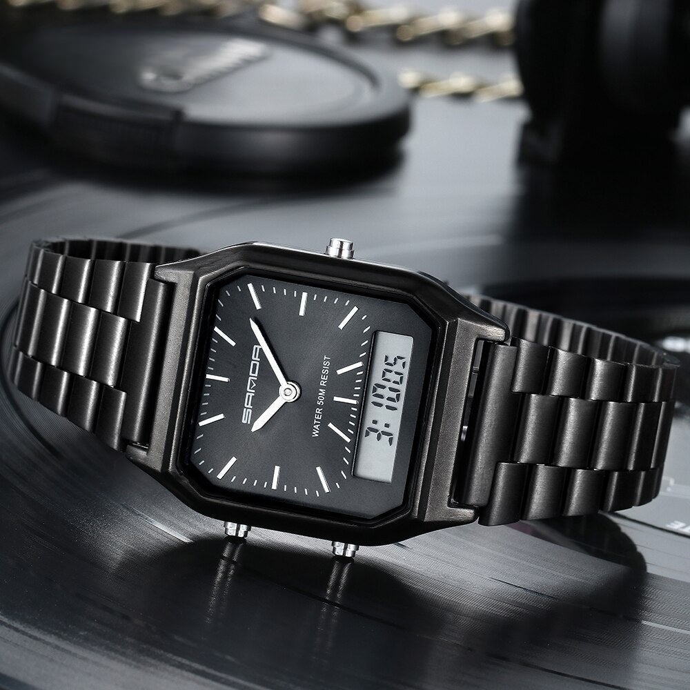 A black Luxury G Style dual display wristwatch with both analog and digital time is shown resting on a dark, reflective surface. White hour markers and hands complement the digital readout, displaying 3:10:05.