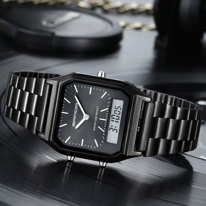 A black Luxury G Style dual display wristwatch with both analog and digital time is shown resting on a dark, reflective surface. White hour markers and hands complement the digital readout, displaying 3:10:05.