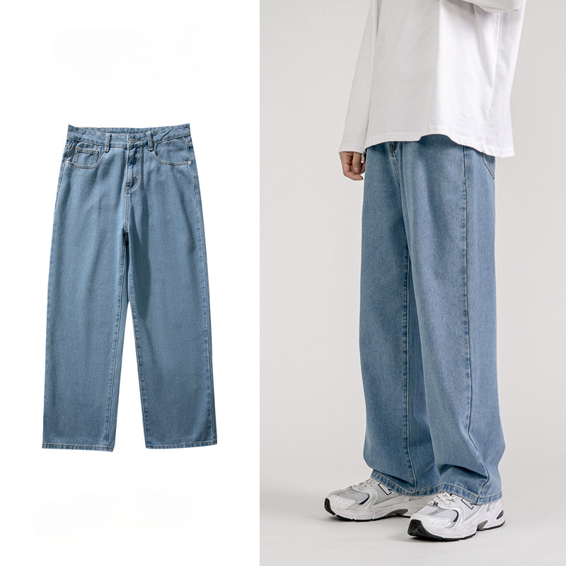 Light blue mens baggy jeans with a wide-leg design shown alone on the left and worn by a person on the right, styled with a loose white long-sleeve shirt and white sneakers for a classic Korean fashion look against a neutral background.