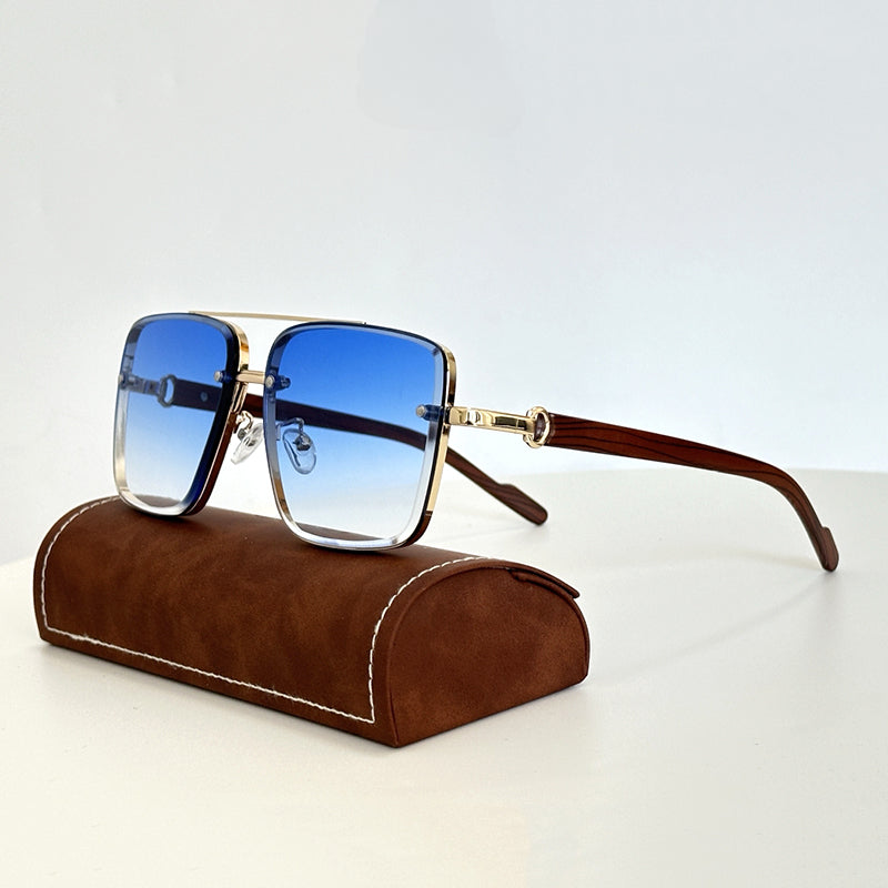 Square-shaped vintage sunglasses with gold frames, wooden arms, and blue gradient lenses featuring UV400 protection are displayed on a brown suede eyeglasses case, set against a plain white background.