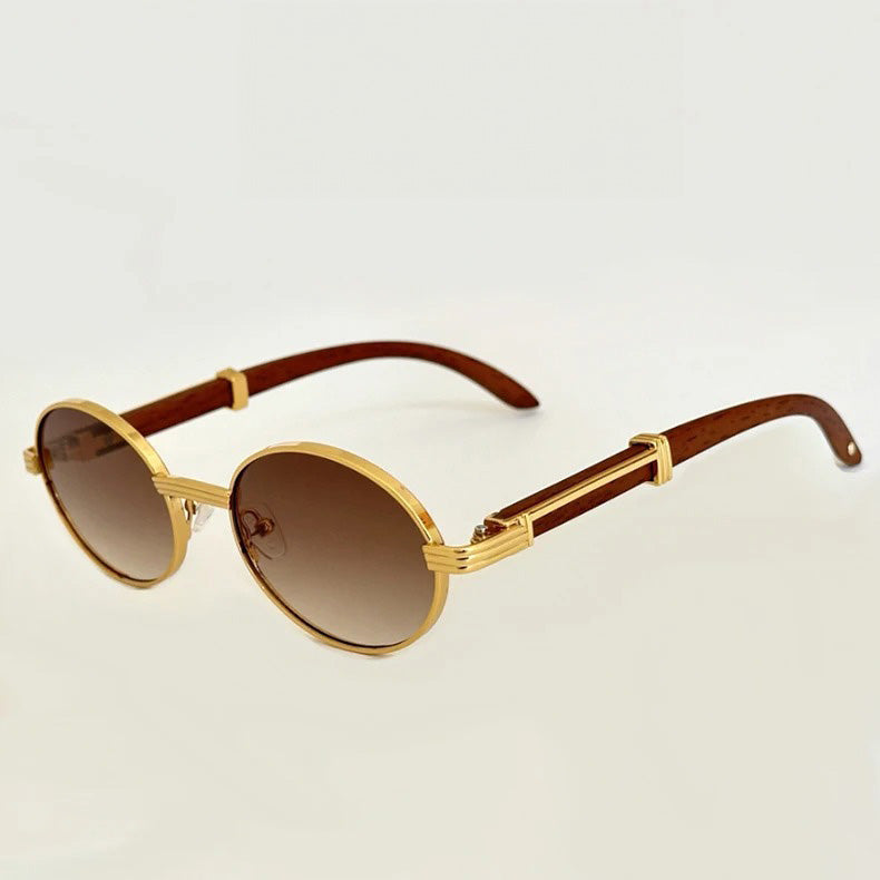 Round, gold-framed vintage round sunglasses with brown gradient lenses and wooden temple arms, offering UV400 protection, displayed on a plain light background.