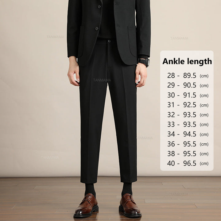 A person wearing a black suit, brown dress shoes, and Mens Slim Casual Trousers stands indoors. A size chart on the right lists ankle lengths in centimeters, from size 28 (89.5 cm) to 40 (96.5 cm), perfect for a business formal look.
