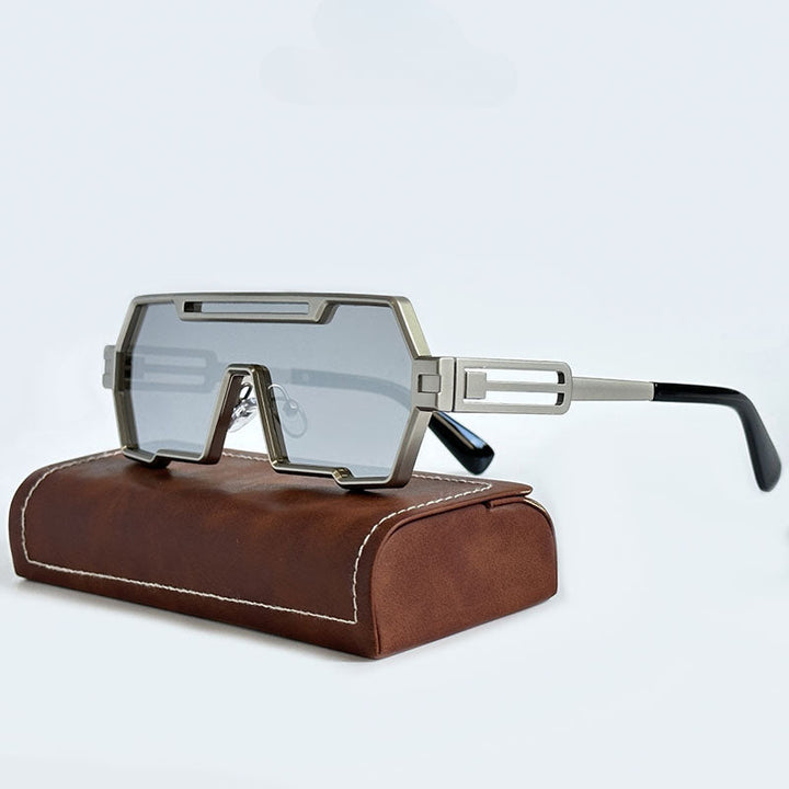 Futuristic, geometric Steampunk Sunglasses with gray-tinted lenses and a silver frame are displayed on a brown leather case against a plain white background.